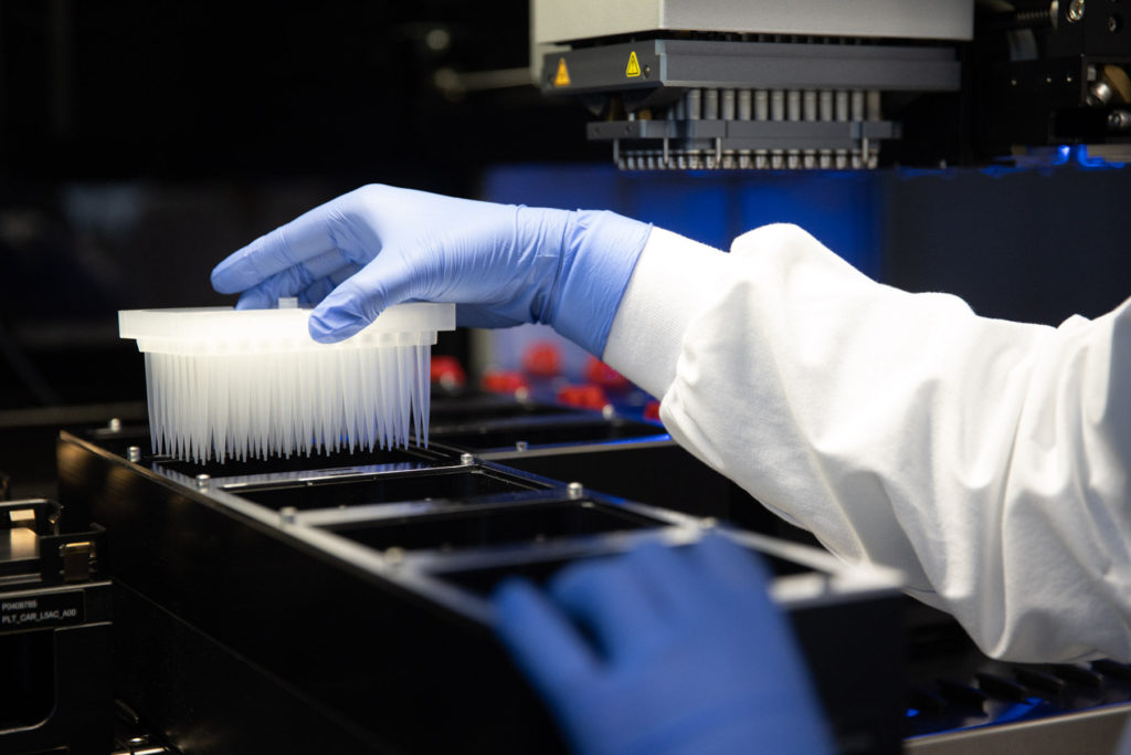 An AbCellera scientist loads a sample to perform high-throughput screening. [credit: AbCellera]