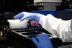 An AbCellera scientist loads asample to perform high-throughput screening. [credit: AbCellera]